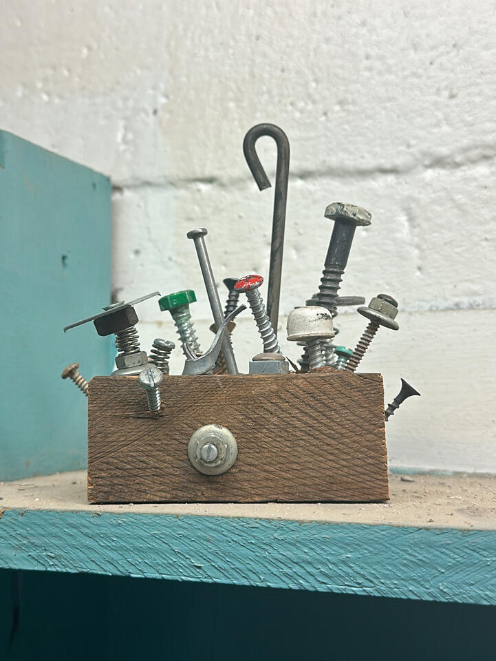 Close-up detail showing rough cuts of wood and vintage hardware sprouting out to make an abstract shelf decor Close-up detail showing rough cuts of wood and vintage hardware sprouting out to make an abstract shelf decor